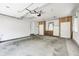 Spacious garage with carpet, cabinets, refrigerator, and multiple doors for easy access at 494 W Greencastle Rd, Mooresville, IN 46158