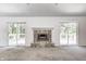 Bright living room with sliding doors on either side of the fireplace at 494 W Greencastle Rd, Mooresville, IN 46158