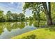 A peaceful pond view with a grassy bank creates a serene and inviting natural landscape at 494 W Greencastle Rd, Mooresville, IN 46158
