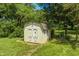 A backyard shed provides extra storage with charming crossbuck doors and a secure space at 494 W Greencastle Rd, Mooresville, IN 46158