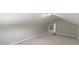 Finished attic offers carpet, light-colored paint, and an access panel at 5209 E North St, Indianapolis, IN 46219