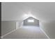 Attic room features carpeting, light-colored walls, and a dormer window at 5209 E North St, Indianapolis, IN 46219