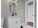 Bathroom features granite counters, a white vanity, and hexagon tile flooring at 5209 E North St, Indianapolis, IN 46219