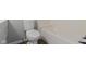 Full bathroom with a toilet, tub, and white subway tile at 5209 E North St, Indianapolis, IN 46219