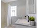 Bathroom with granite countertop, white vanity, black faucet and shower with curtain at 5209 E North St, Indianapolis, IN 46219