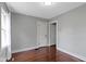 Bright bedroom features hardwood floors, neutral paint, and natural light from the window at 5209 E North St, Indianapolis, IN 46219