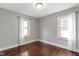 Neutral bedroom with hardwood floors, lots of natural light, and white window curtains at 5209 E North St, Indianapolis, IN 46219
