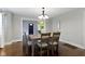 Cozy dining room with hardwood floors, modern lighting, and a view into the home's entryway at 5209 E North St, Indianapolis, IN 46219