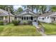 Charming single-story home with a well-kept lawn, landscaped yard, and welcoming front porch at 5209 E North St, Indianapolis, IN 46219