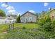 Charming home with green grass, well-manicured landscaping, and a gray-painted porch and railing at 5209 E North St, Indianapolis, IN 46219