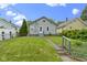 Charming home with green grass, well-manicured landscaping, and a gray-painted porch and railing at 5209 E North St, Indianapolis, IN 46219