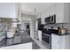 Open kitchen showcasing granite countertops, stainless appliances, and eat-in breakfast nook at 5209 E North St, Indianapolis, IN 46219