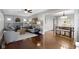 Spacious living room flows into dining area, featuring hardwood floors and neutral paint at 5209 E North St, Indianapolis, IN 46219