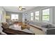 Bright and airy living room showcasing hardwood floors, large windows, and a view to the front entry at 5209 E North St, Indianapolis, IN 46219