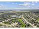 Aerial view of the community with a pond and a nearby airport. The neighborhood features sidewalks and green lawns at 5220 Orahood Ct, Plainfield, IN 46168