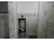 Hallway view of a bathroom with floral wallpaper at 5220 Orahood Ct, Plainfield, IN 46168