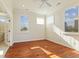 Bedroom with hardwood floors, three large windows that let in a great deal of natural light, and white trim at 5220 Orahood Ct, Plainfield, IN 46168