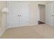 Cozy bedroom with plush carpet, white trim and doors, and a wall lamp for ambient lighting at 5220 Orahood Ct, Plainfield, IN 46168