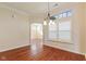 Bright dining room featuring hardwood floors, shutters, elegant lighting, and an open floor plan at 5220 Orahood Ct, Plainfield, IN 46168