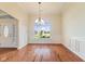 Dining room with hardwood floors and ample natural light from a large window at 5220 Orahood Ct, Plainfield, IN 46168