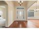 Bright foyer with hardwood floors and elegant chandelier at 5220 Orahood Ct, Plainfield, IN 46168