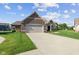 Charming single-story home featuring a brick facade, well-manicured lawn, and an attached two-car garage, enhancing curb appeal at 5220 Orahood Ct, Plainfield, IN 46168