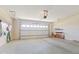 Spacious two-car garage with overhead storage and a well-lit interior, offering ample space for vehicles and storage at 5220 Orahood Ct, Plainfield, IN 46168