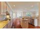 Bright kitchen features granite countertops, stainless steel appliances, hardwood floors, and pendant lighting at 5220 Orahood Ct, Plainfield, IN 46168