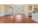 Open-concept living room boasts hardwood floors, decorative molding, and a large window with outdoor views at 5220 Orahood Ct, Plainfield, IN 46168