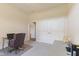 Well-lit office space features neutral walls and carpet with a desk, chair, and closet with paneled doors at 5220 Orahood Ct, Plainfield, IN 46168