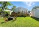 Enjoy the spacious backyard with a wooden deck, a fire pit, and a detached garage at 5312 Norwaldo Ave, Indianapolis, IN 46220