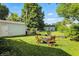 This spacious backyard offers a detached garage and a fire pit sitting area at 5312 Norwaldo Ave, Indianapolis, IN 46220