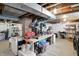 Unfinished basement featuring a workbench, shelving, and concrete flooring for a versatile workspace at 5312 Norwaldo Ave, Indianapolis, IN 46220