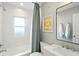 Clean bathroom with a shower/tub, vanity with sink, and artwork on the wall at 5312 Norwaldo Ave, Indianapolis, IN 46220