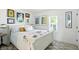 Bright bedroom with a sleigh bed, white walls, a neutral area rug and many art pieces at 5312 Norwaldo Ave, Indianapolis, IN 46220