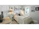 Charming bedroom featuring a bed with decorative pillows, a desk and multiple artworks on the walls at 5312 Norwaldo Ave, Indianapolis, IN 46220
