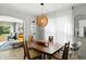 Elegant dining room with modern light fixture and view to the living room at 5312 Norwaldo Ave, Indianapolis, IN 46220