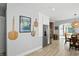 Bright dining area with wood floors and an arched entryway, complete with stainless steel fridge at 5312 Norwaldo Ave, Indianapolis, IN 46220