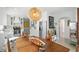 Bright dining area with a modern light fixture and fruit display on the wood table at 5312 Norwaldo Ave, Indianapolis, IN 46220