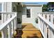 Inviting front porch with wooden deck and potted plants for a warm welcome at 5312 Norwaldo Ave, Indianapolis, IN 46220