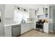 This kitchen features white cabinetry, stone countertops and backsplash and stainless appliances at 5312 Norwaldo Ave, Indianapolis, IN 46220