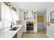 Updated kitchen featuring white cabinets, stainless steel appliances, and decorative backsplash at 5312 Norwaldo Ave, Indianapolis, IN 46220
