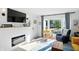 Cozy living room with fireplace, large windows, and comfortable armchair seating at 5312 Norwaldo Ave, Indianapolis, IN 46220