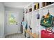 Well-organized mudroom with cubbies, a bench, and an exterior door providing ample natural light at 5312 Norwaldo Ave, Indianapolis, IN 46220