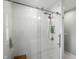 Modern bathroom shower with glass door, white subway tile, and sleek shower fixtures at 5312 Norwaldo Ave, Indianapolis, IN 46220