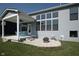 Backyard view features a covered patio, fire pit, and a well-maintained lawn at 5351 Rose Dr, Zionsville, IN 46077