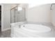 Bathroom featuring a bathtub and glass enclosed shower at 5351 Rose Dr, Zionsville, IN 46077