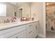 Bathroom featuring double sinks, white cabinets, and a patterned shower curtain adding style and privacy at 5351 Rose Dr, Zionsville, IN 46077