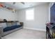 Cozy bedroom features a comfortable sofa, window, and shelves, creating a relaxing atmosphere at 5351 Rose Dr, Zionsville, IN 46077