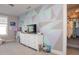 Bedroom featuring a colorful accent wall and a walk-in closet at 5351 Rose Dr, Zionsville, IN 46077